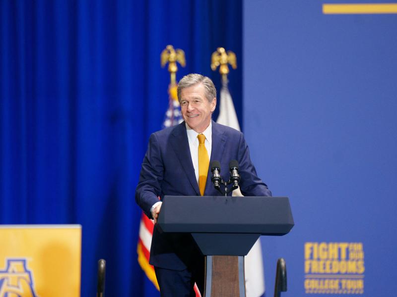 Senate candidate and former North Carolina Gov. Roy Cooper speaks at a podium