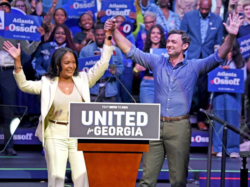 Jon Ossoff and Keisha Lance Bottoms join hands at a Democratic unity rally
