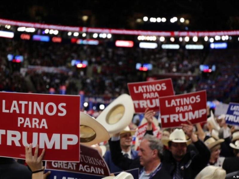 People hold "Latinos para Trump" signs at the Republican National Convention in 2016